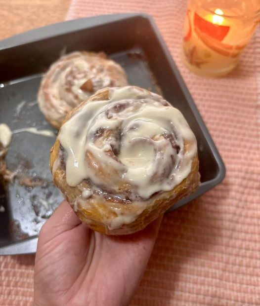 A soft, pumpkin cinnamon roll topped with cream cheese maple glaze