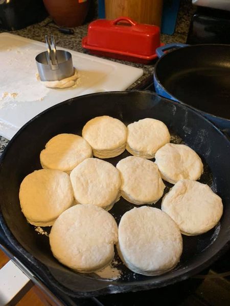 Unbaked biscuits placed neatly in a cast iron skillet.