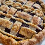 Golden brown four berry pie ready for slicing