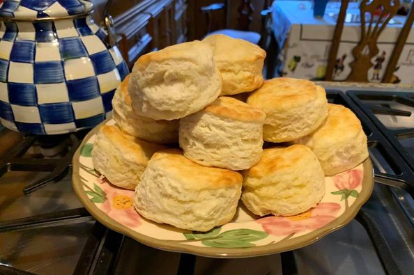 Freshly baked White Lily buttermilk biscuits stacked on a plate