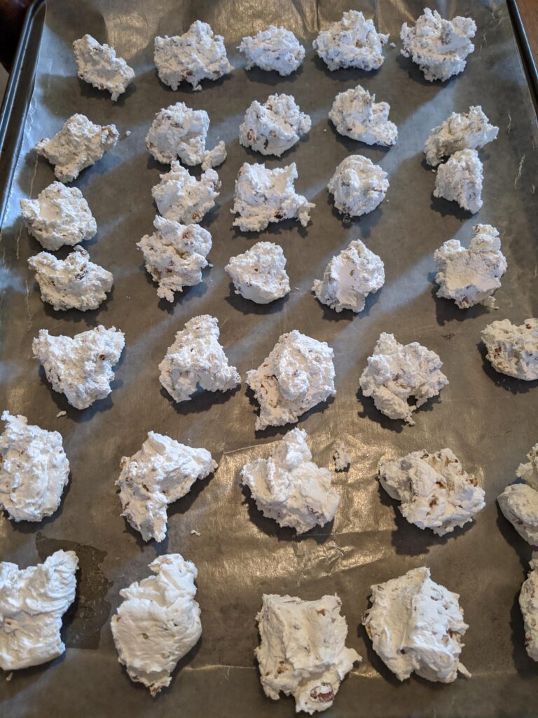 homemade divinity candy dropped onto a baking sheet, before it has completely set