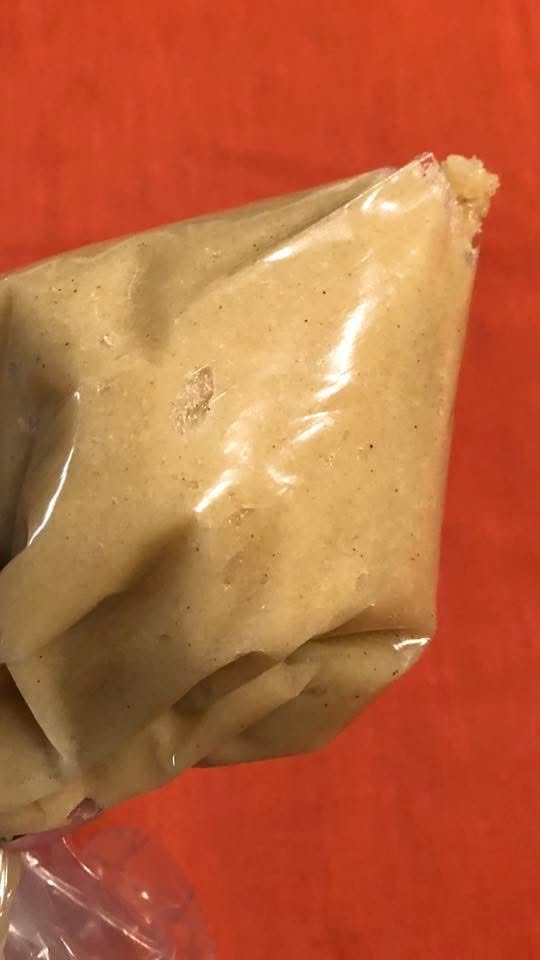 the prepared almond cookie dough inside a piping bag