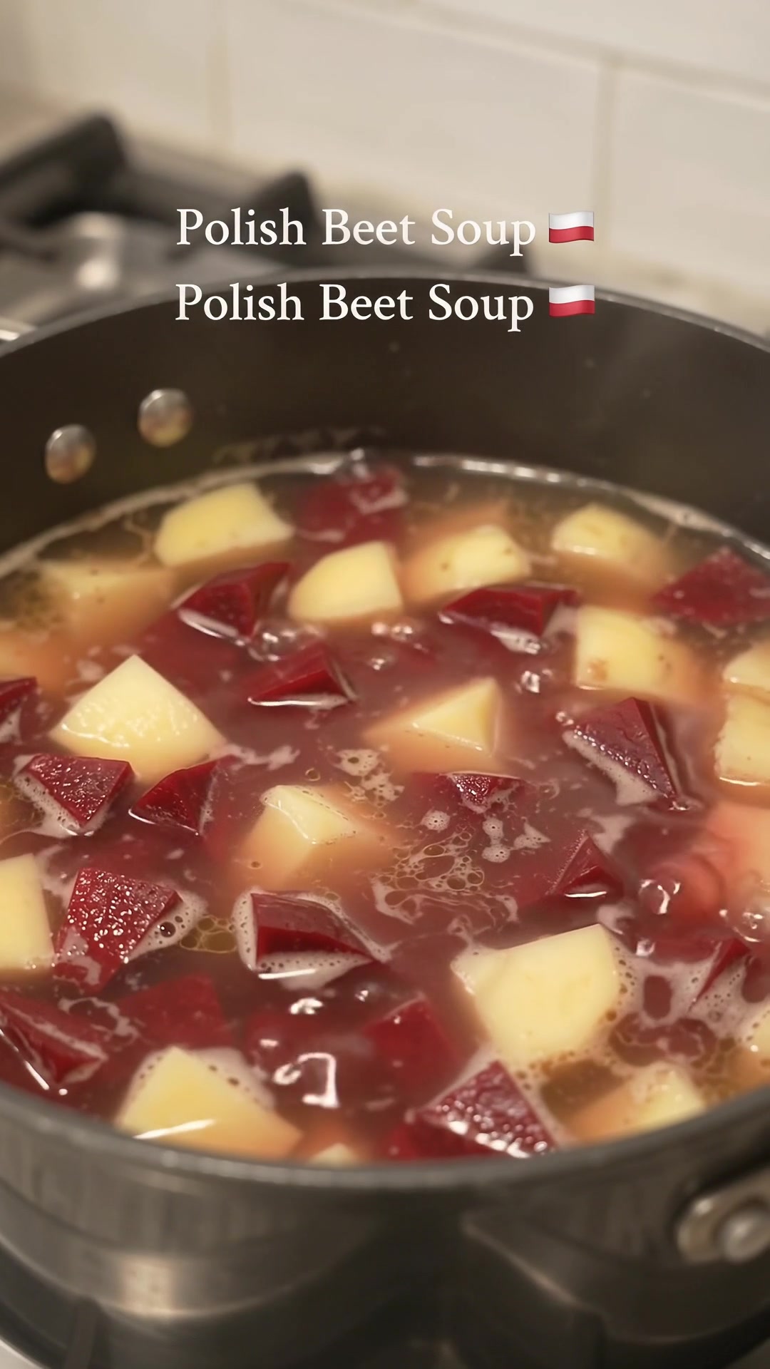Diced red beets and potatoes simmering in broth in a large pot for Polish Zupa Buraczkowa.