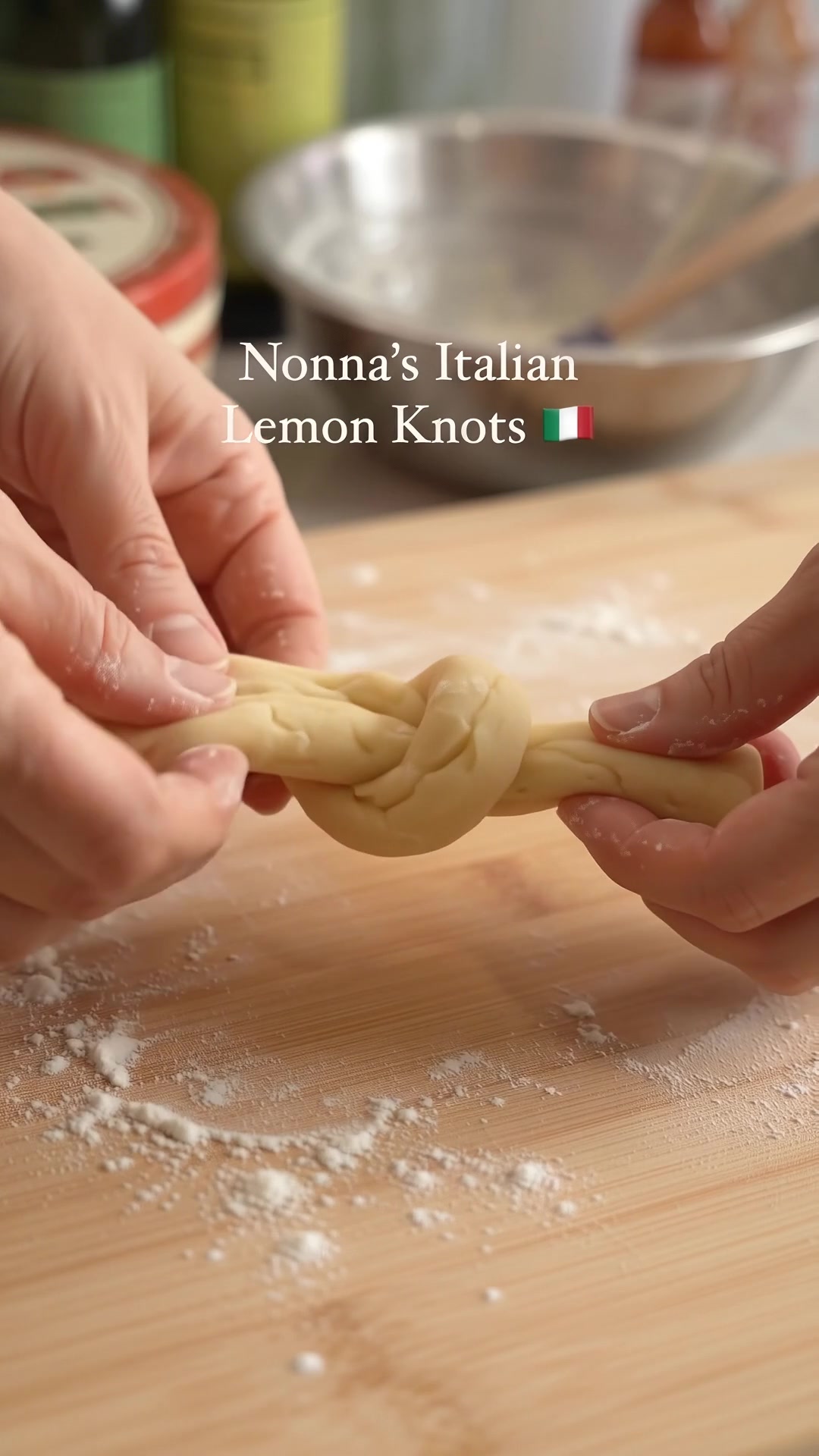 Hands shaping soft Italian lemon cookie dough into a traditional knot.