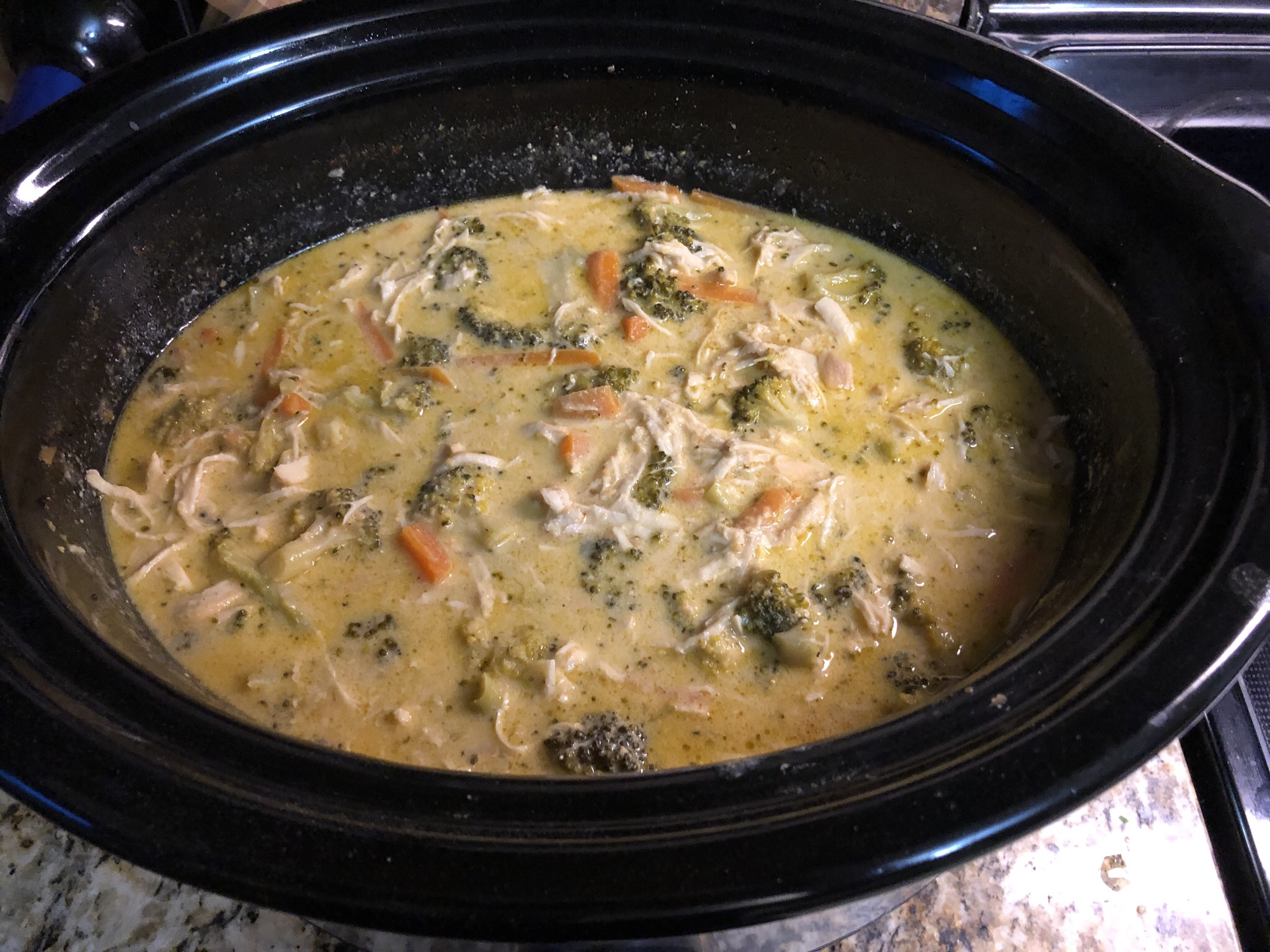 Slow cooker cheesy chicken and broccoli with tender shredded chicken, melted cheese, and creamy sauce.